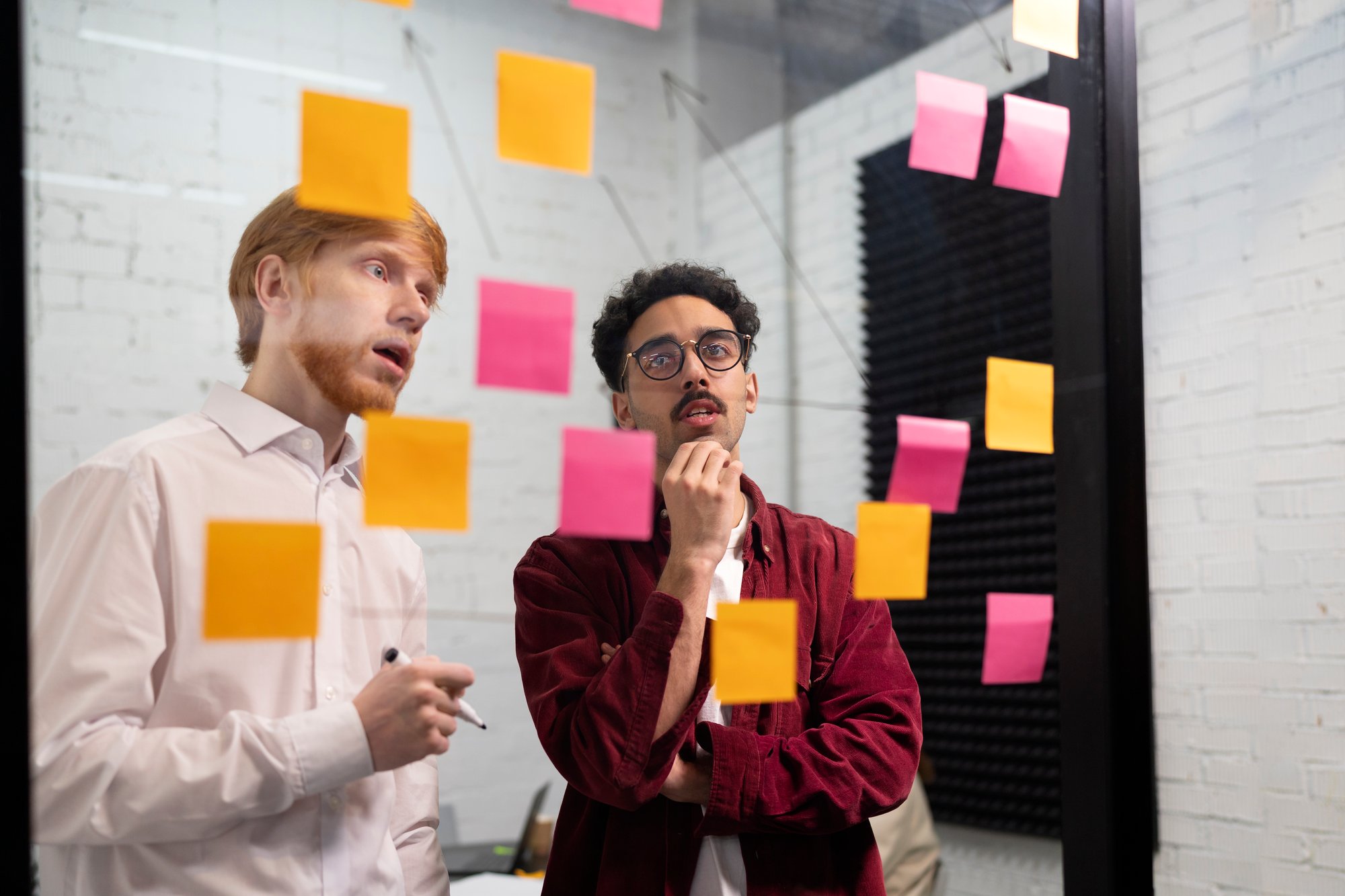 colleagues-looking-post-its-medium-shot