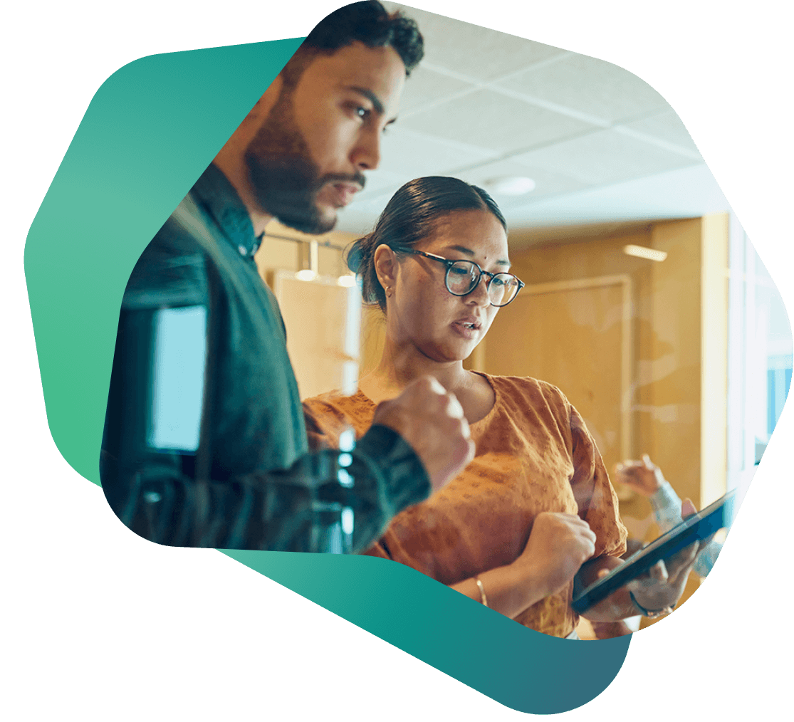 Two financial professionals collaborating on lending calculations, reflecting accuracy, compliance, and teamwork in financial decision-making.
